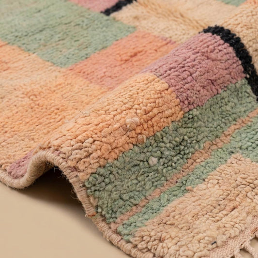 Close up view of textured pile showing peach sage and cream color blocks