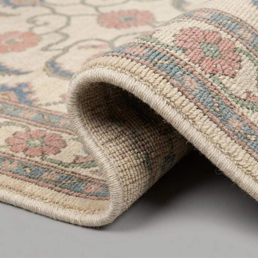 Close up of hand knotted wool pile showing detailed floral knots, soft wool fibers and traditional artisan weaving texture __etsy:7849317063