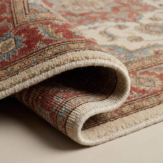 Close-up of hand knotted wool rug showing individual knot structure, dense wool fibers, low pile texture, and traditional knot-by-knot craftsmanship.