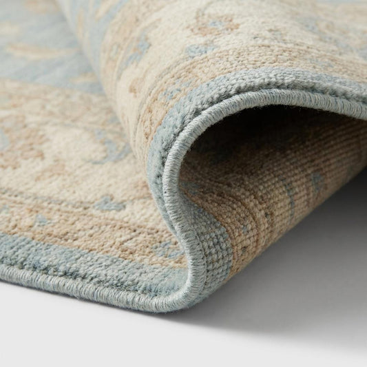 Close-up of hand knotted wool pile showing individual knots and natural fiber texture