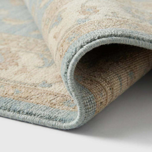 Close-up of hand knotted wool pile showing individual knots and natural fiber texture