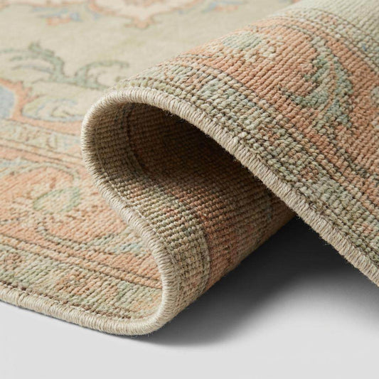 Close up of hand knotted wool pile showing dense knots, soft fibers, and vintage finish