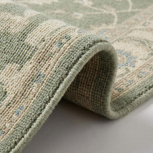 Close-up of hand knotted wool rug showing individual knots, soft wool pile, and natural texture