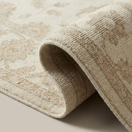 Close-up of hand knotted wool pile showing dense knots, natural fibers, and soft texture