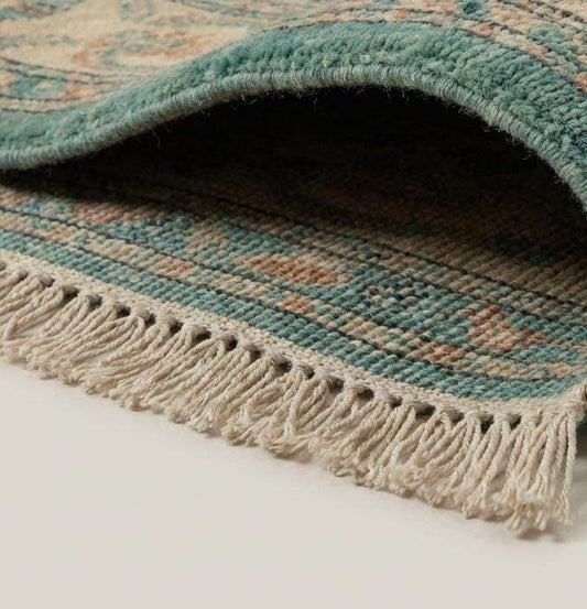 Close-up of hand knotted wool pile showing dense knot structure and natural fiber texture