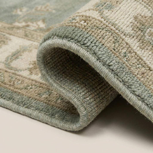 Hand knotted sage green Oushak wool rug with floral medallion design