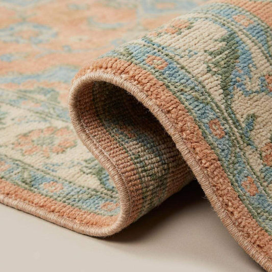Close up of hand knotted wool pile showing natural fibers and artisan knot structure