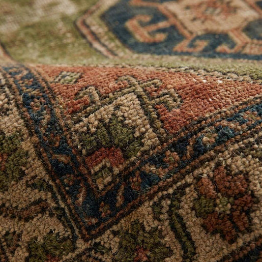 Tribal hand knotted wool rug with geometric Oushak style medallion design in earthy olive and rust tones