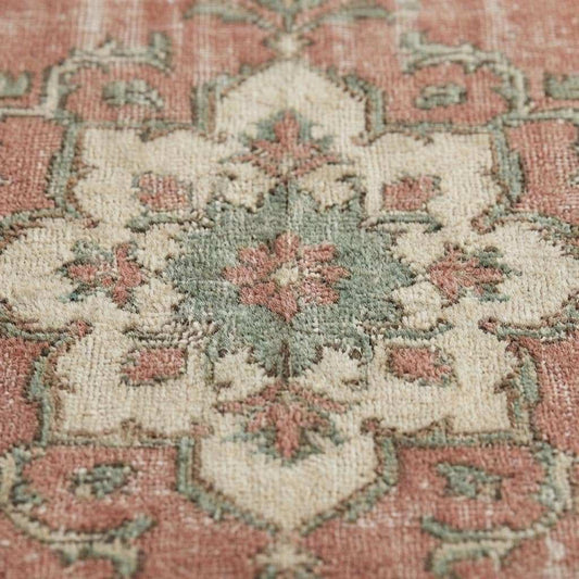 Close up of hand knotted wool pile showing low pile texture, natural wool fibers, and vintage wear