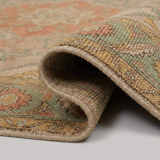 Close up of hand knotted wool rug showing dense pile, natural fibers, and artisan knot structure