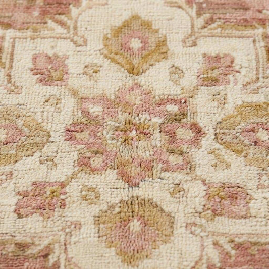 Close-up of hand knotted wool pile showing low pile texture, natural fibers, and subtle abrash variations