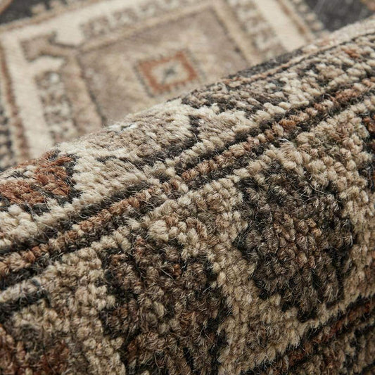 Close-up of hand knotted wool rug showing dense knot structure, natural wool fibers, and artisan craftsmanship