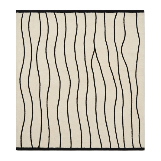 Black and White Wavy Line Rug with an ivory ground, flowing black stripes, and a crisp black border