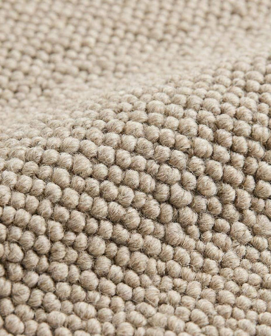 Chunky wool loop rug in neutral beige with textured, handmade cozy minimalist design