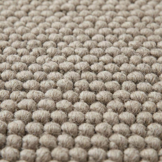 Chunky wool rug with thick loop weave in neutral beige, minimalist Scandinavian style living room decor