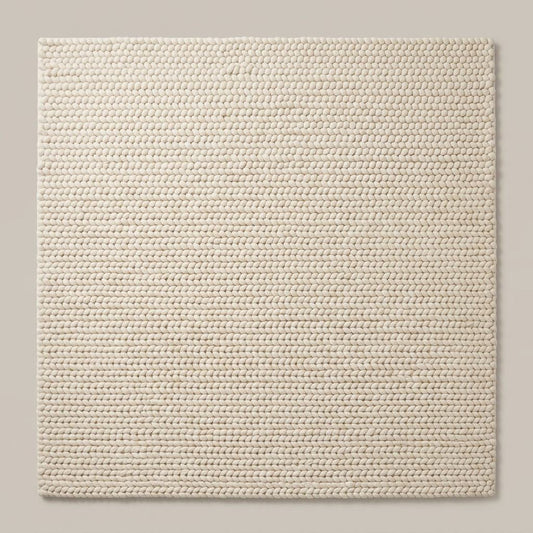 Chunky Wool Rug in ivory cream, with a thick, tightly braided knit texture and neatly aligned rows of loops.
