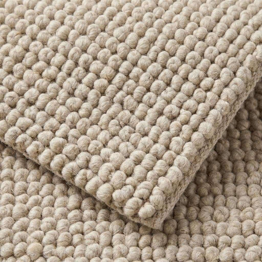 Chunky wool rug with neutral tones and handwoven thick loop pile for cozy minimalist farmhouse and Scandinavian decor