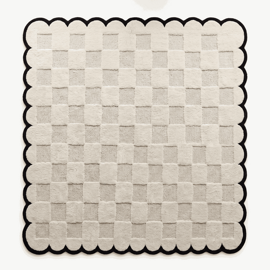 Cream & Black Checkered hand-tufted wool rug with a raised cream checkerboard and bold black scalloped border
