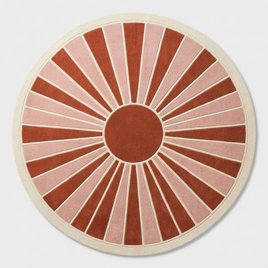 Oval Handmade Retro Rug in terracotta and blush pink wool, with ivory-outlined sunburst rays and a wide ivory border.