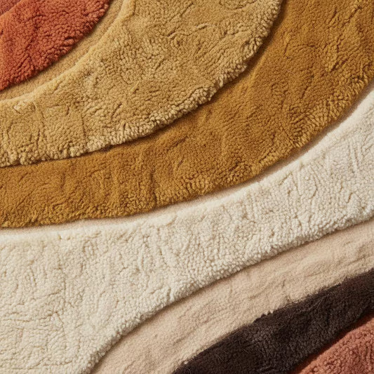 Mid century modern hand-tufted abstract area rug in terracotta, mustard, and cream with geometric patterns