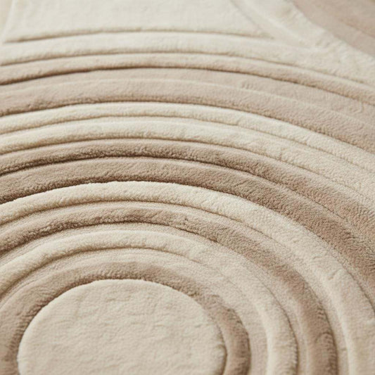 Close-up detail of a handmade tufted rug showing textured wool and stitching