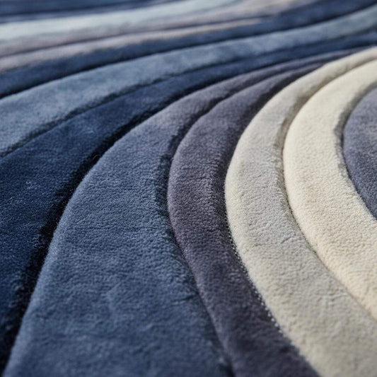 Mid century modern rug with blue sculpted wave pattern and plush textured surface
