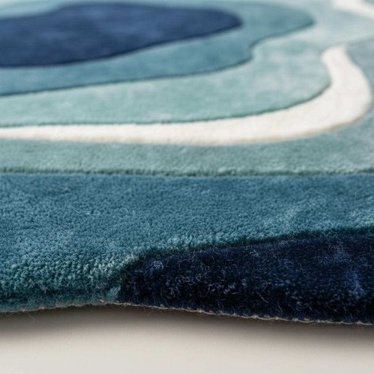 Close-up detail of a handmade tufted rug showing textured wool and stitching