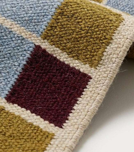 Handwoven flatweave checkered wool rug with mustard, dusty blue, burgundy, and ivory geometric pattern for modern living room decor