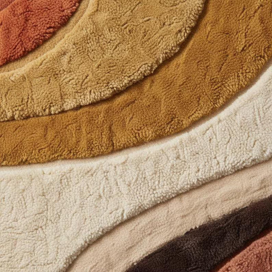 Mid century modern hand-tufted abstract area rug in terracotta, mustard, and cream with geometric patterns