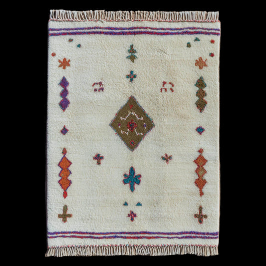 Handmade Moroccan Azilal-style wool rug with colorful tribal geometric motifs on an ivory background, perfect for boho living room décor.
