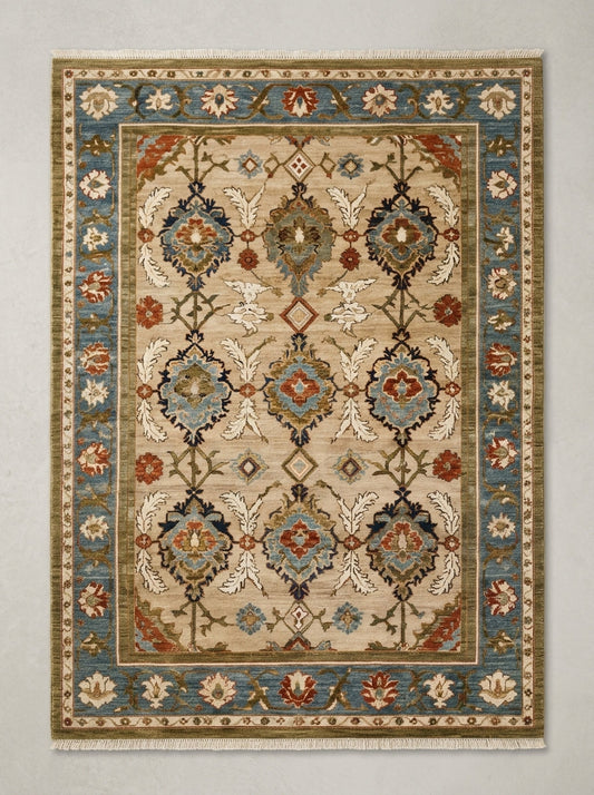 Oushak Hand Knotted Rug in camel beige wool, with a floral lattice, slate blue border and short fringe.