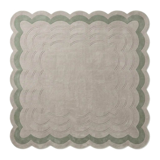 Sage Green Scalloped Echo hand-tufted wool rug in pale greige and sage green, with carved rippling lines and scalloped edges.