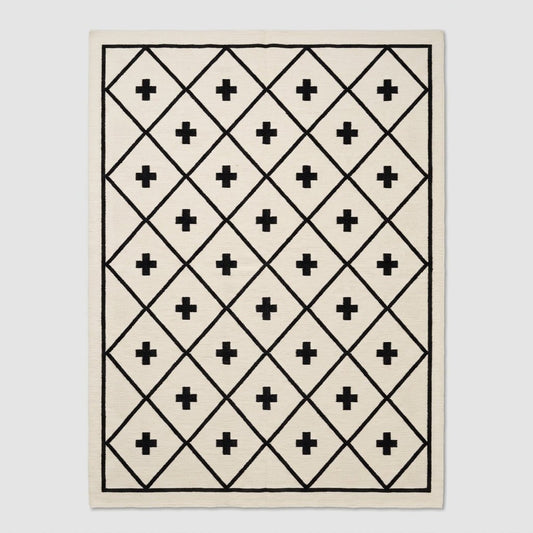 Southwestern Flatweave Wool Rug in ivory with a black diamond lattice, Swiss cross motifs, and slim border.