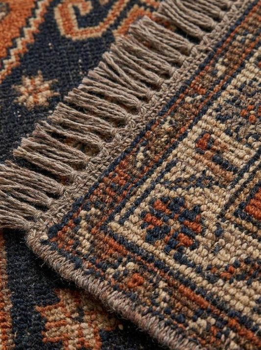 Hand-knotted vintage tribal runner rug with geometric medallions and animal motifs in rust orange and gray tones