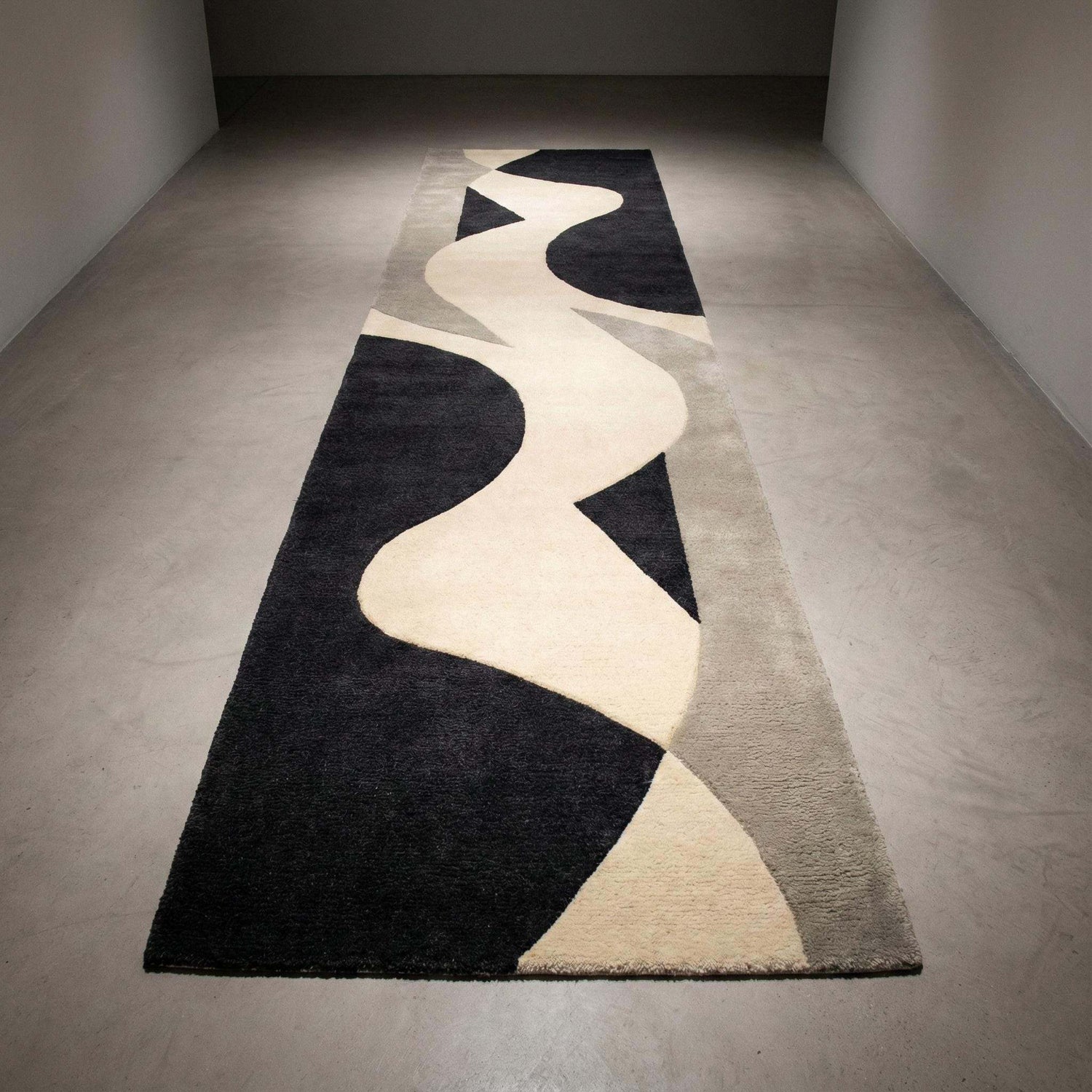 Handmade black wool rugs with modern minimalist design adding elegance and contrast to interiors