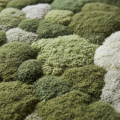 Handmade 3D moss rug with green textured pebble design and soft cushioned surface for organic indoor decor