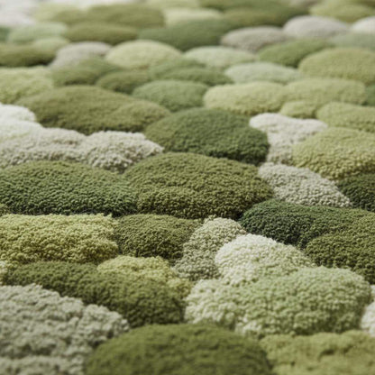 Handmade 3D moss rug with green textured pebble design and soft cushioned surface for organic indoor decor