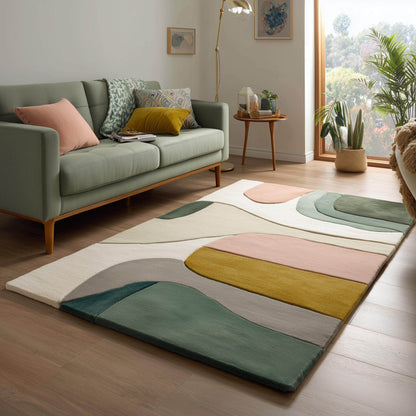 Mid-century color block area rug with geometric design in soft neutral tones of sage green, blush, mustard, cream, and grey.