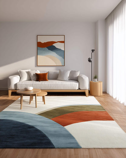 Abstract Color Block Rug with curved geometric pattern in terracotta, sage, layered blues, and navy on soft ivory base for modern living spaces