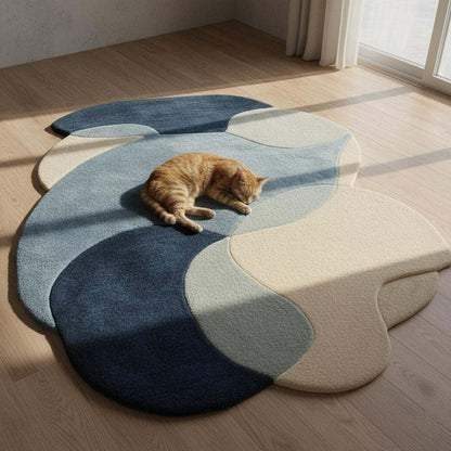 Abstract pebble rug in blue and beige with freeform organic shape and plush cut pile surface