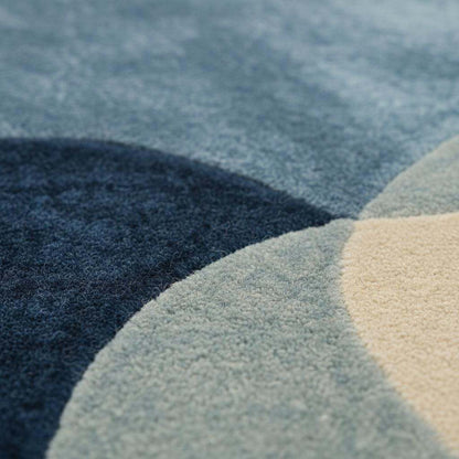 Abstract pebble rug in blue and beige with freeform organic shape and plush cut pile for modern living spaces