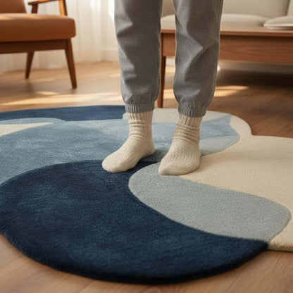 Abstract pebble rug with freeform blue and beige shapes and plush cut pile surface