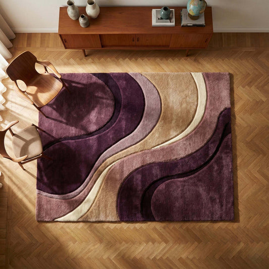 Abstract wave hand tufted area rug with flowing curved design in plum, mauve, beige and cream tones, styled in a modern living room with wooden flooring. __etsy:7568857173
