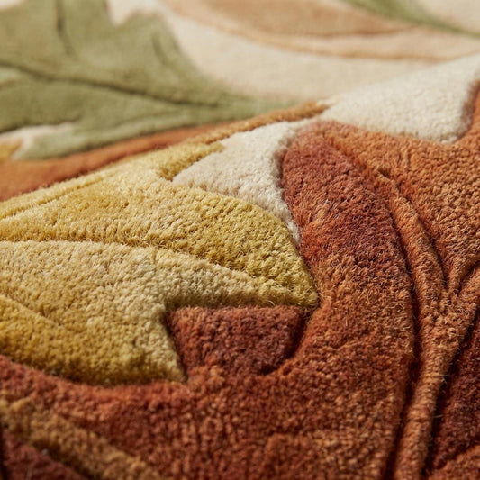 Close-up of hand tufted leaf rug showing thick plush fibers, carved leaf pattern, soft textured pile detail