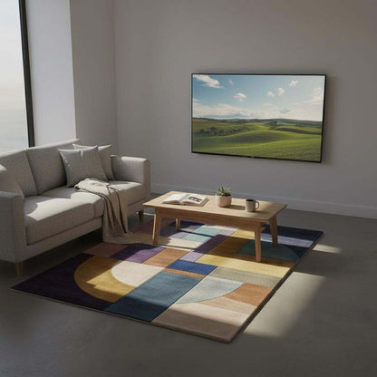 Vibrant 9x12 Bauhaus area rug with abstract geometric shapes in purple, yellow, teal, pink, and mauve for modern home decor