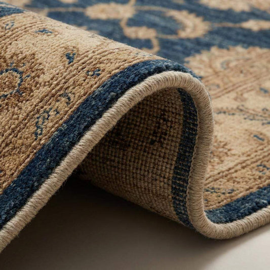Close-up of hand knotted wool rug showing dense pile, individual knots, and natural wool texture