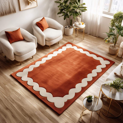 Burnt orange area rug with handmade tufted wool and wavy cream Scandinavian border