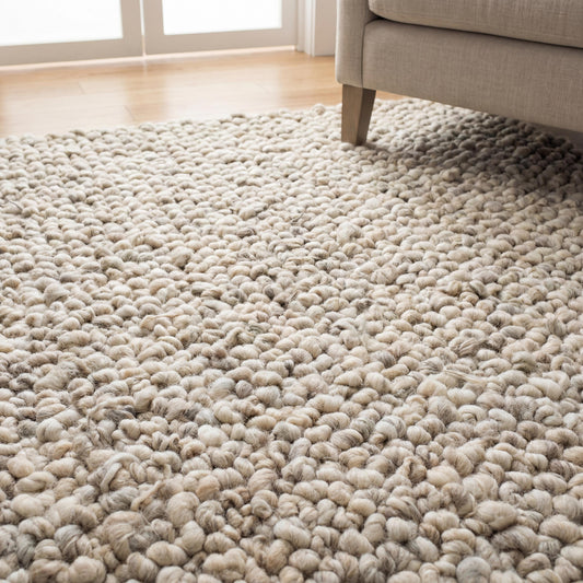 Chunky knit area rug with thick wool loop texture in neutral tones for cozy, modern home decor