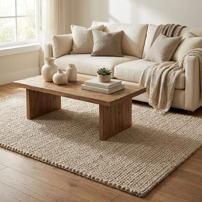 Chunky knit beige braided rug with thick textured wool-look and plush soft surface for cozy living room