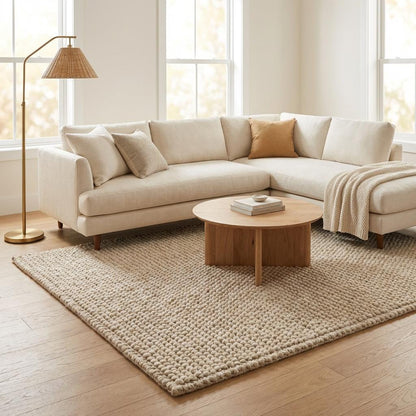 Chunky knit neutral rug with thick oversized loops and warm natural fiber texture for cozy Scandinavian homes
